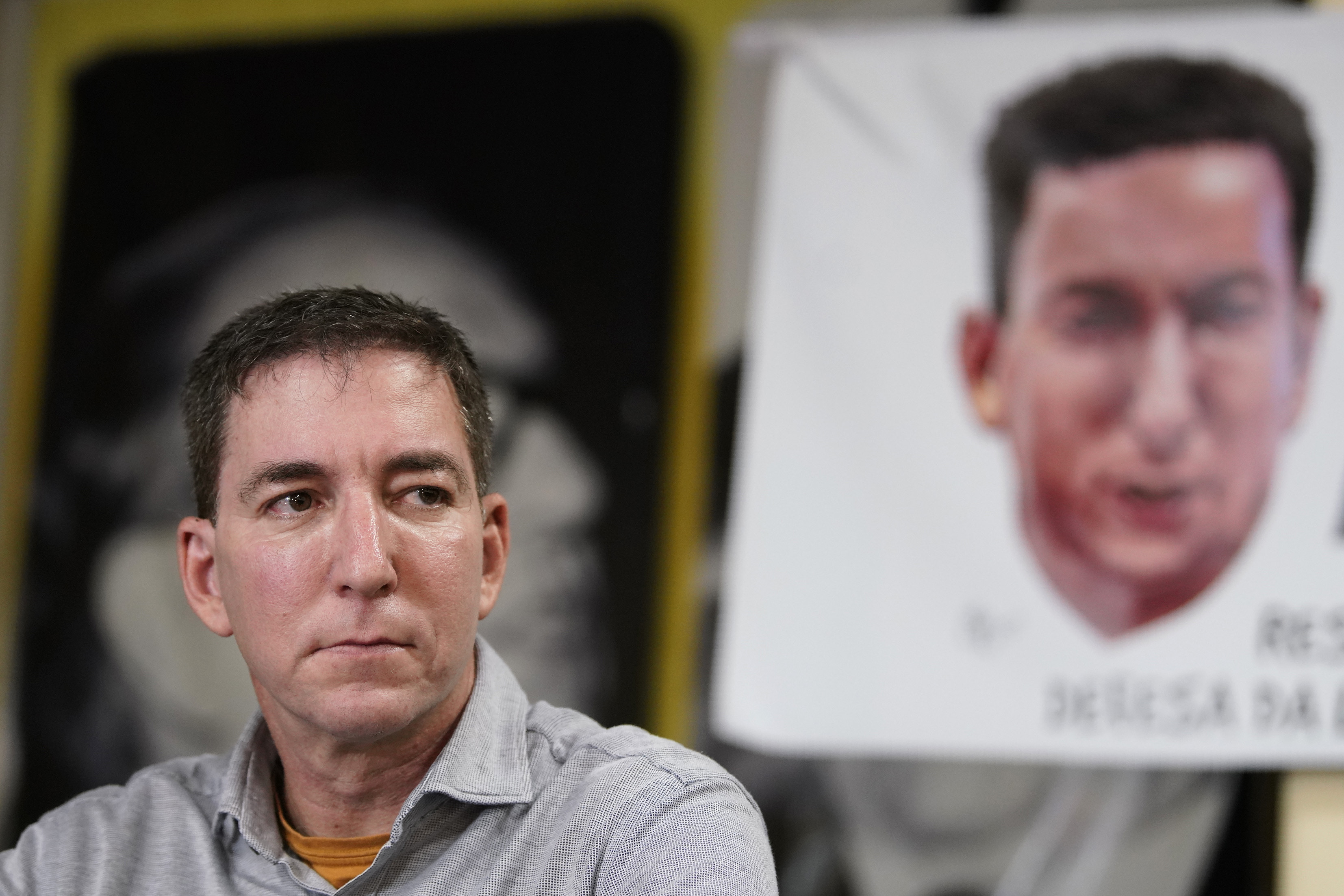 Award-winning journalist Glenn Greenwald listens to questions during a press conference before the start of a protest in his support in front of the headquarters of the Brazilian Press Association on July 30, 2019.