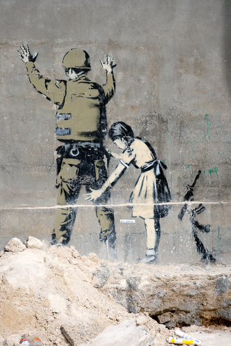 BETHLEHEM, PALESTINIAN TERRITORIES - JANUARY 25: Banksy grafitti on a wall in the occupied territories. Bethlehem, January 25, 2010.
