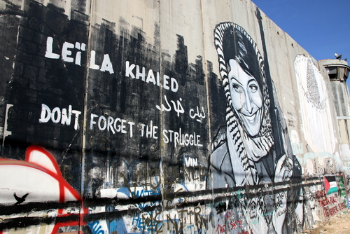 Bethlehem wall mural of Leila Khaled OCCUPIED PALESTINIAN TERRITORIES - OCTOBER 7, 2014: Activist graffiti adorns the Israeli separation wall in the West Bank town of Bethlehem on October 7, 2014.