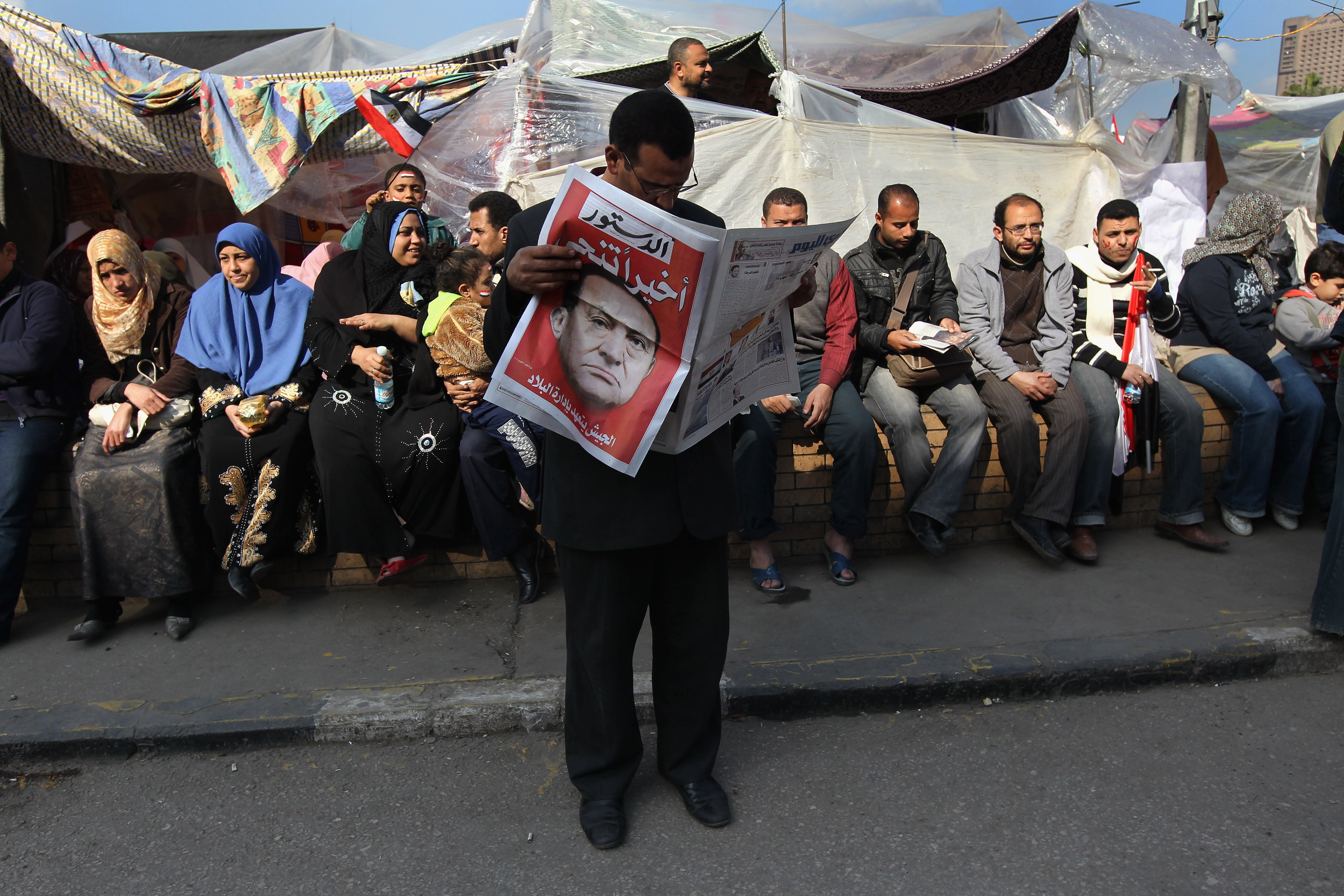  Protesters at an encampment in Tahrir Square begin the day reading newspapers detailng the resignation of President Hosni Mubarak, the headline reads "Finally he is out", on February 12, 2011 in Cairo, Egypt. 