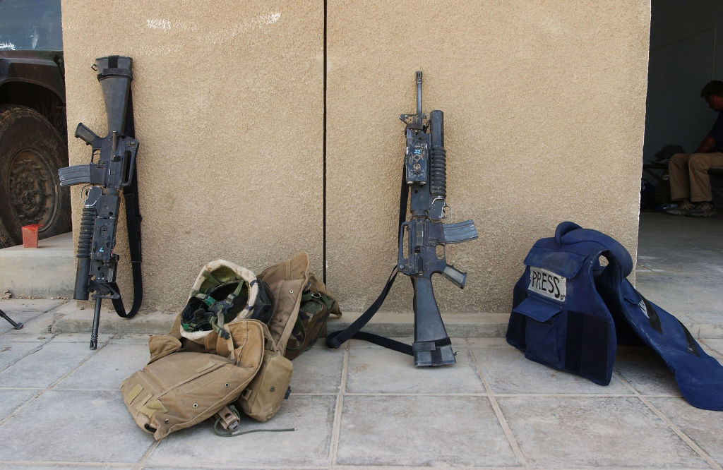 FALLUJAH, IRAQ - MAY 5: The armored vest of an embedded journalist lies next to guns and vests of U.S. Marines May 5, 2004, in Fallujah, Iraq. U.S. (Photo by Scott Peterson/Getty Images)