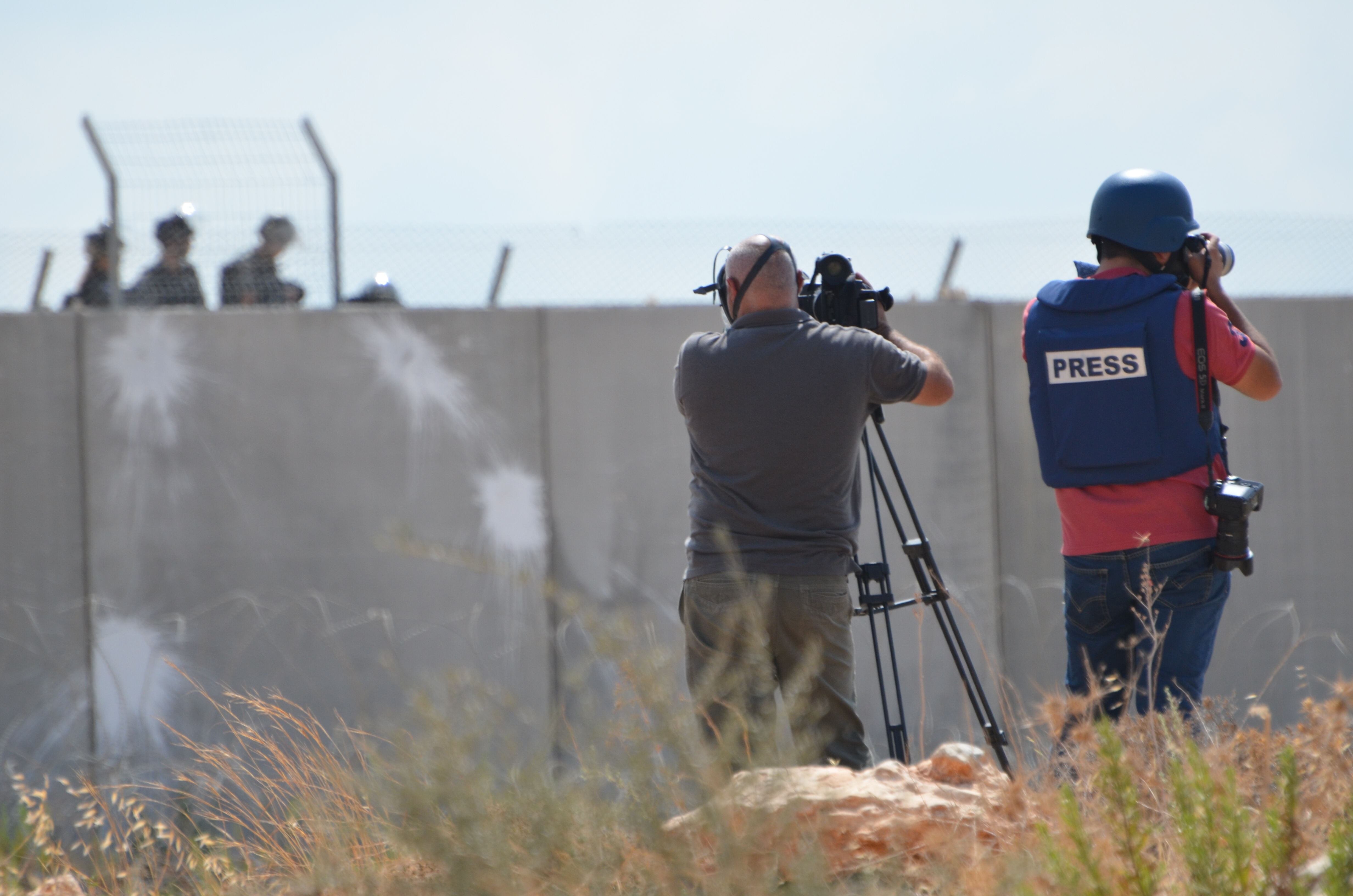 Journalists film the Israeli military during the Friday protests in Bilin, Palestine. 16/06/15