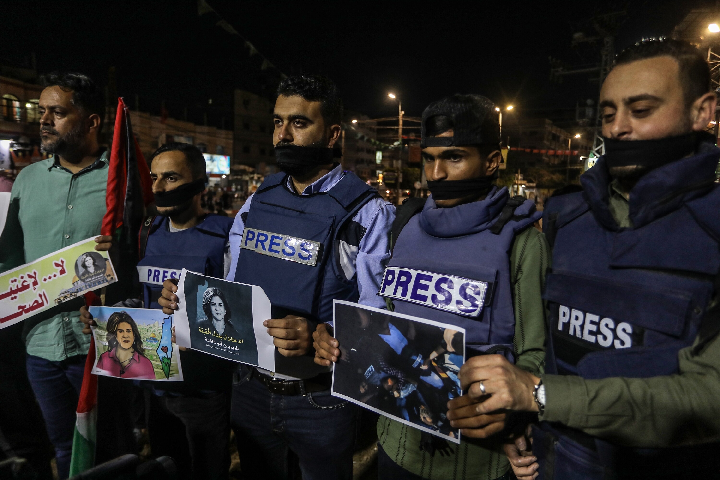 Palestinians take part in a candlelight vigil to condemn the killing of veteran Al Jazeera journalist Shireen Abu Aqleh, in Rafah, in the southern Gaza Strip, on May 11, 2022. (By Anas Mohammed)