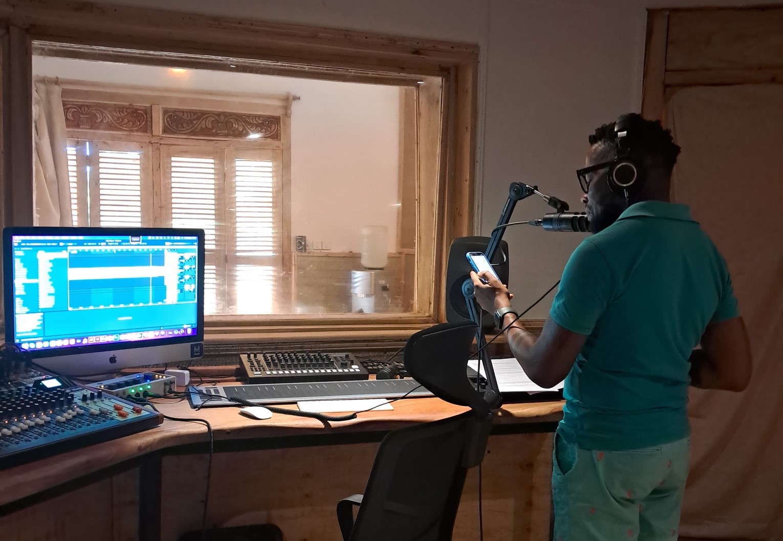 Kevin Mwachiro in studio in Kenya