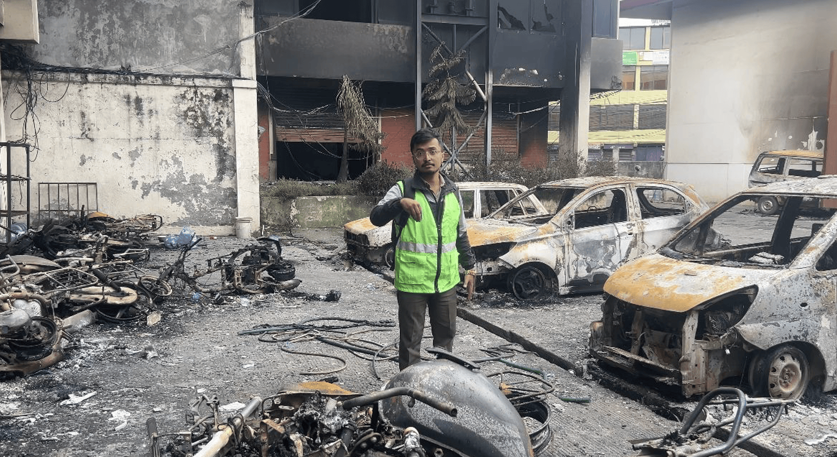 Kiran Paudel outside his Kantipur office which was burnt