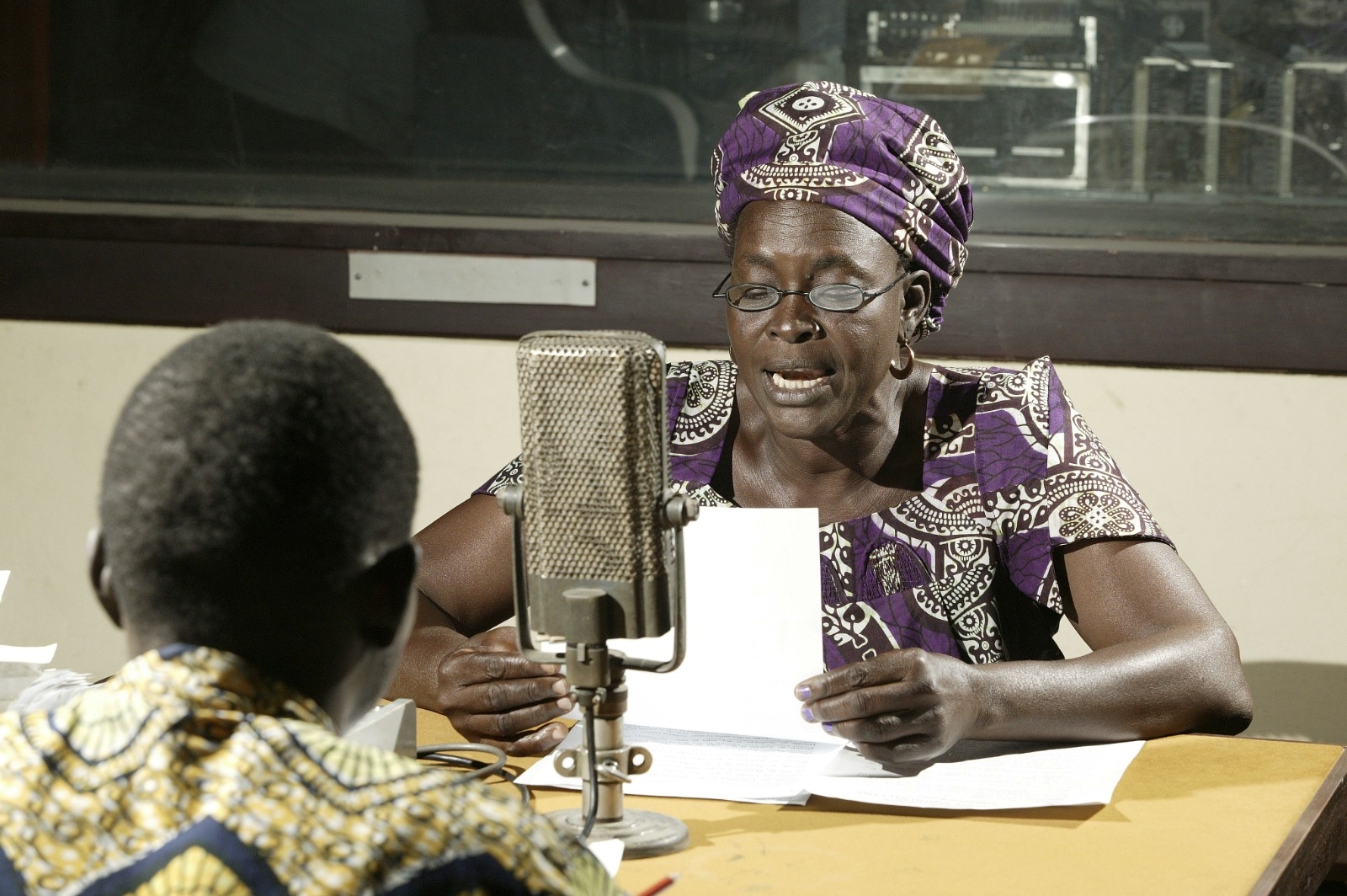Woman talking on-air at a radio station, Garoua, Cameroon, Africa. 