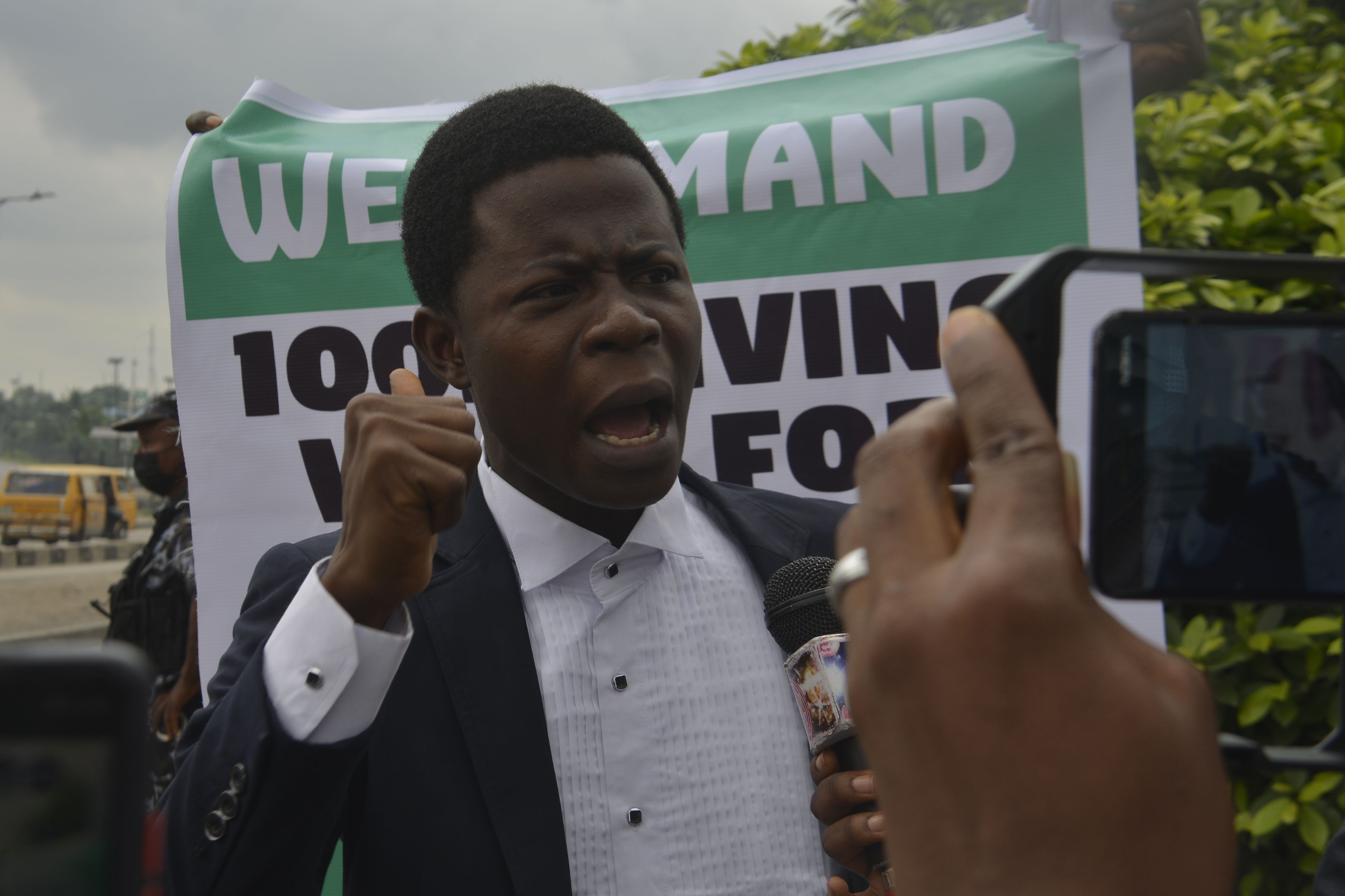 A Nigerian journalist interviews activist Festus Ogun during a protest in the Ojota district of Lagos, Nigeria. Demonstrators gathered to express their grievances regarding nationwide insecurity, economic challenges, and lawlessness. Photo: Olukayode Jaiyeola/NurPhoto (October 1, 2021).
