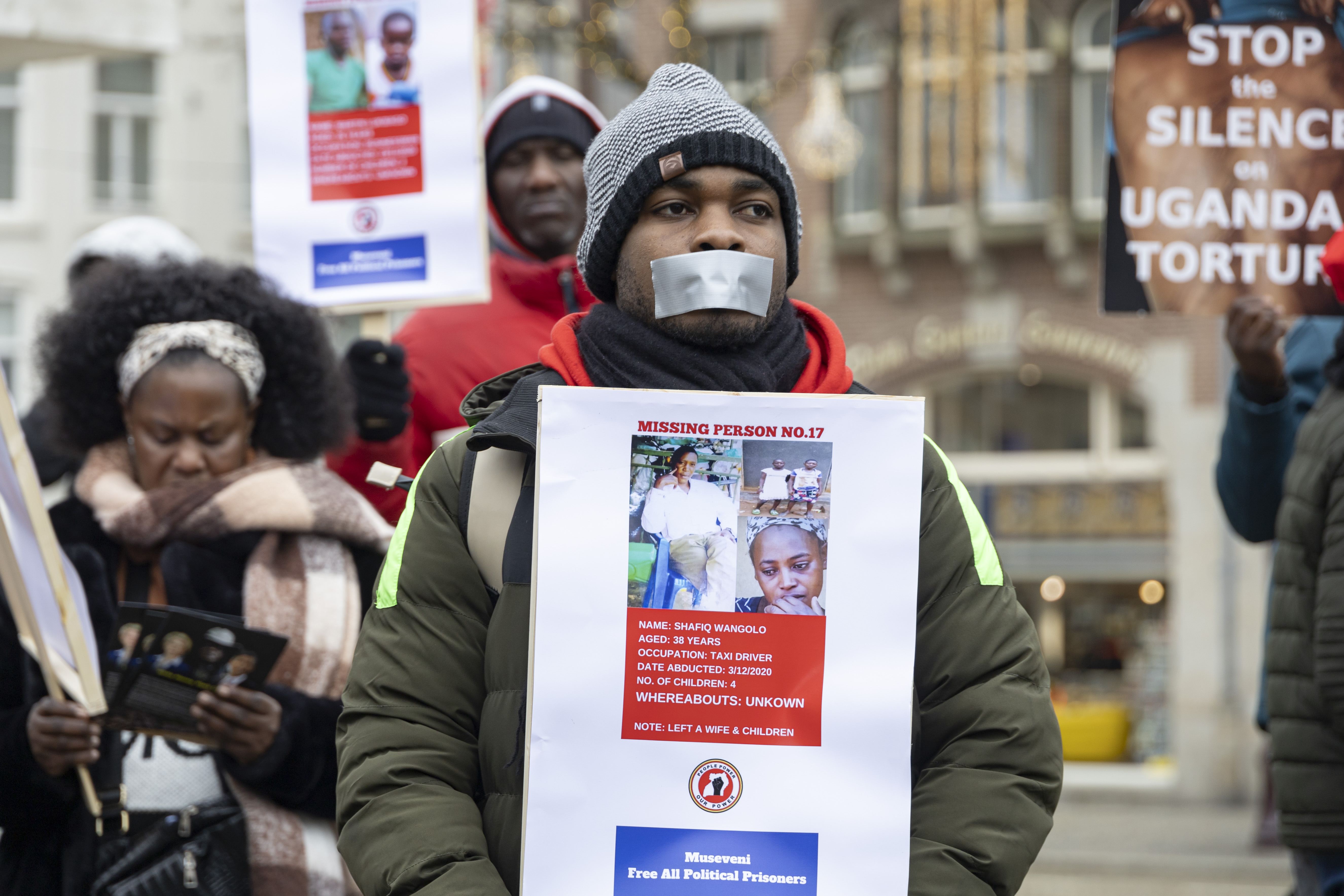 An African demonstrator in Amsterdam uses tape to symbolize the silencing of public opinion and the press. While this protest specifically targets government authoritarianism, a growing threat to African journalism comes from within the community itself.  (Photo: Nicolas Economou/NurPhoto. Amsterdam, Netherlands – Jan 2024)