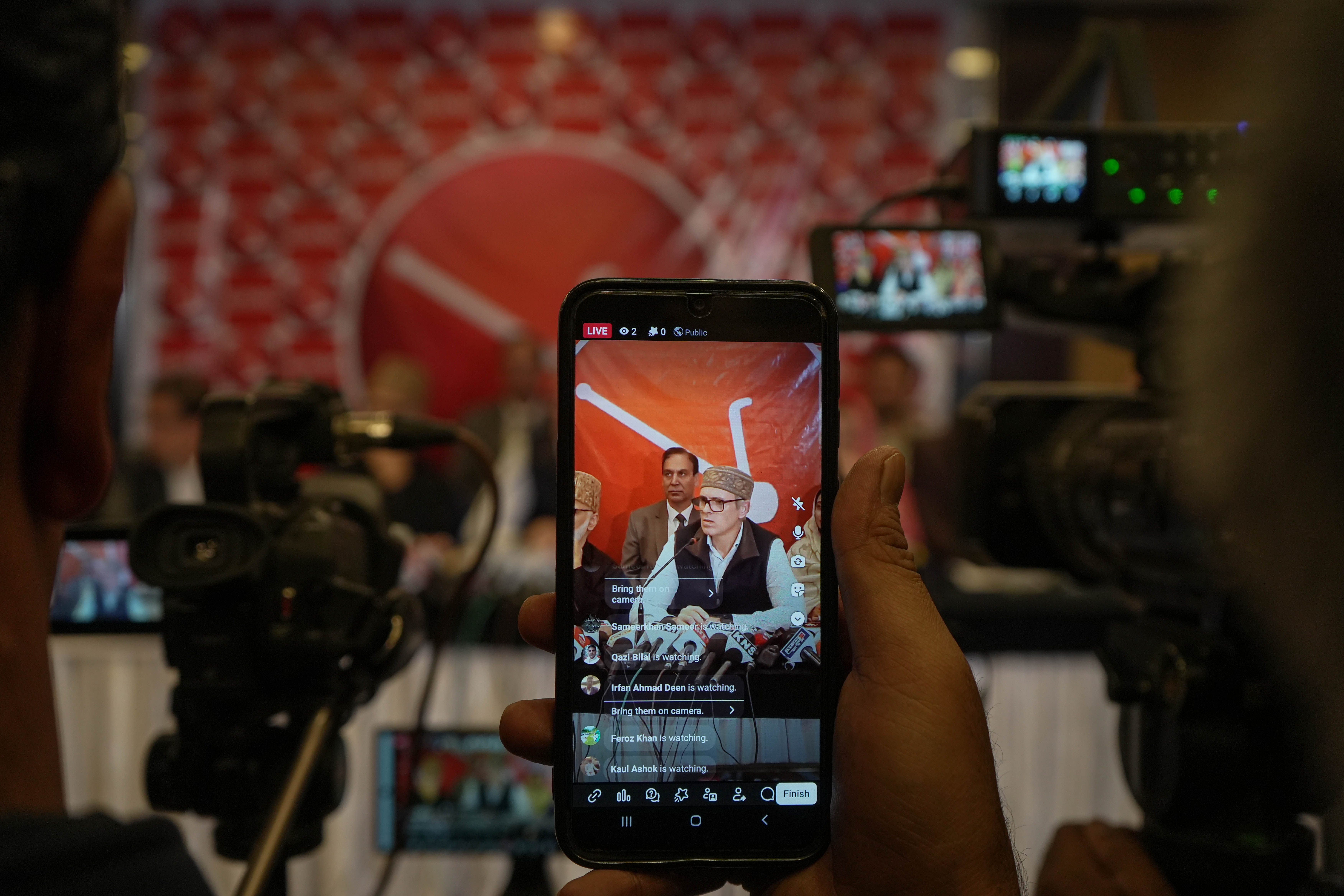 A Kashmiri female journalist broadcasts a live telecast of Omar Abdullah, Chief Minister of India's Jammu and Kashmir region, speaking during a press conference in Srinagar. The press interaction addressed regional governance and the political landscape following the restoration of the elected state government. (Photo: Firdous Nazir/NurPhoto. Srinagar, Jammu and Kashmir, India – Oct 2025)