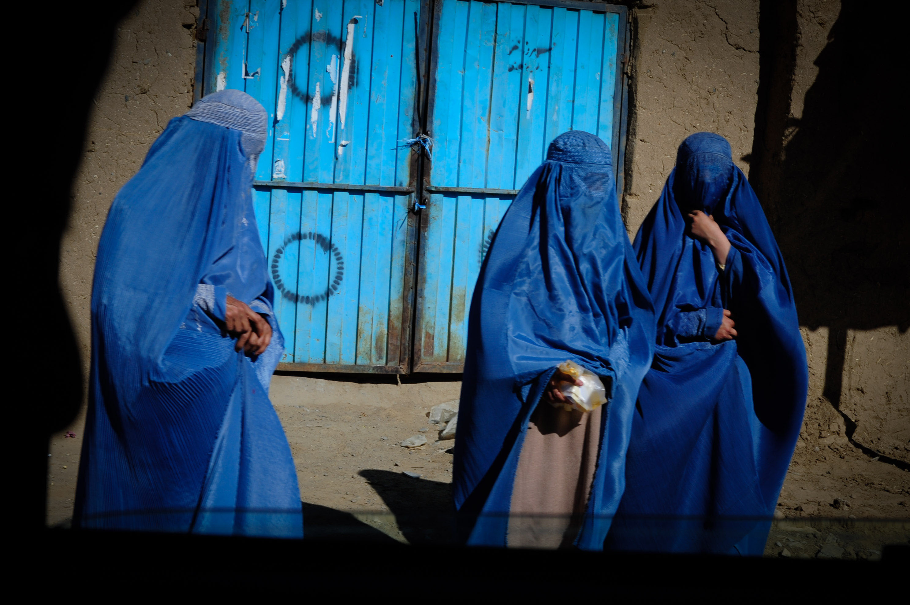 Afghan women walk down a street in Kabul. (Photo: David Honl/ZUMA Press Wire. Kabul, Afghanistan – May 2011)