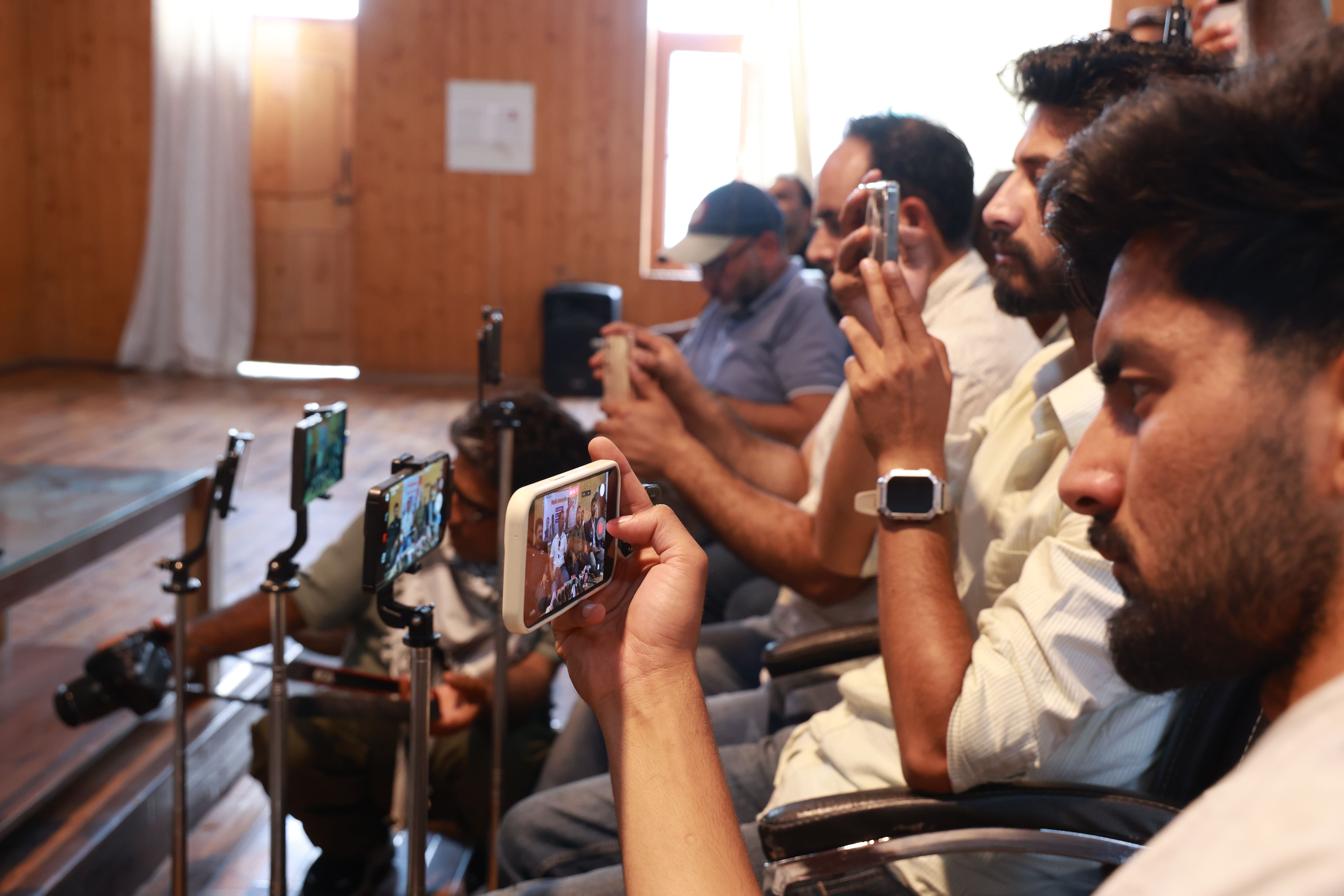 Journalists use mobile phones to cover a press conference in Kashmir, reflecting a growing preference for smartphones over traditional video cameras in digital newsgathering. (Photo: Nasir Kachroo/NurPhoto. Kashmir – Jun 2026)