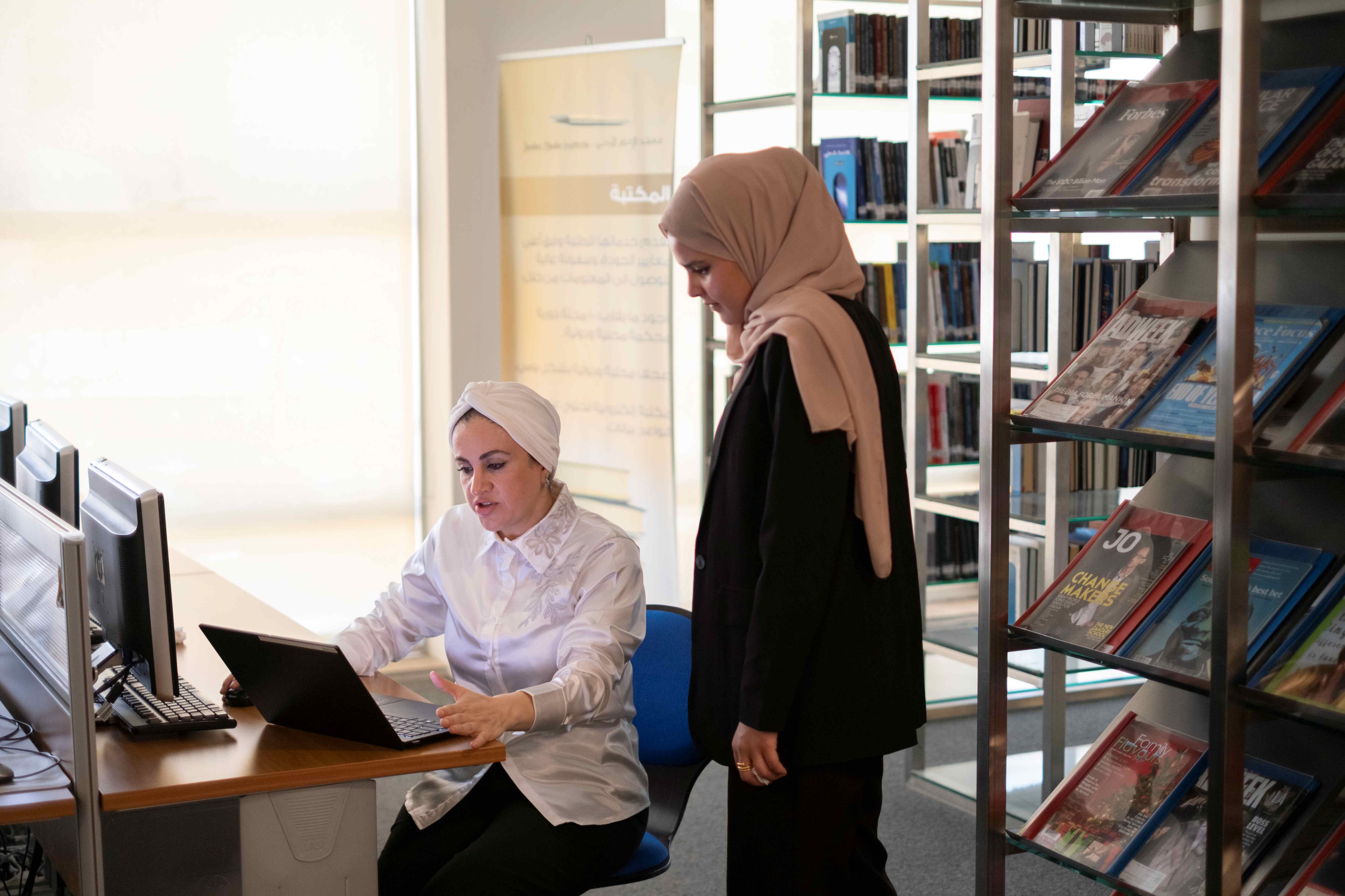 Safaa explains to Afnan, the author, how to connect an AI platform to her documents and workspace (June 1, 2025), Photo Credit: UNESCO 