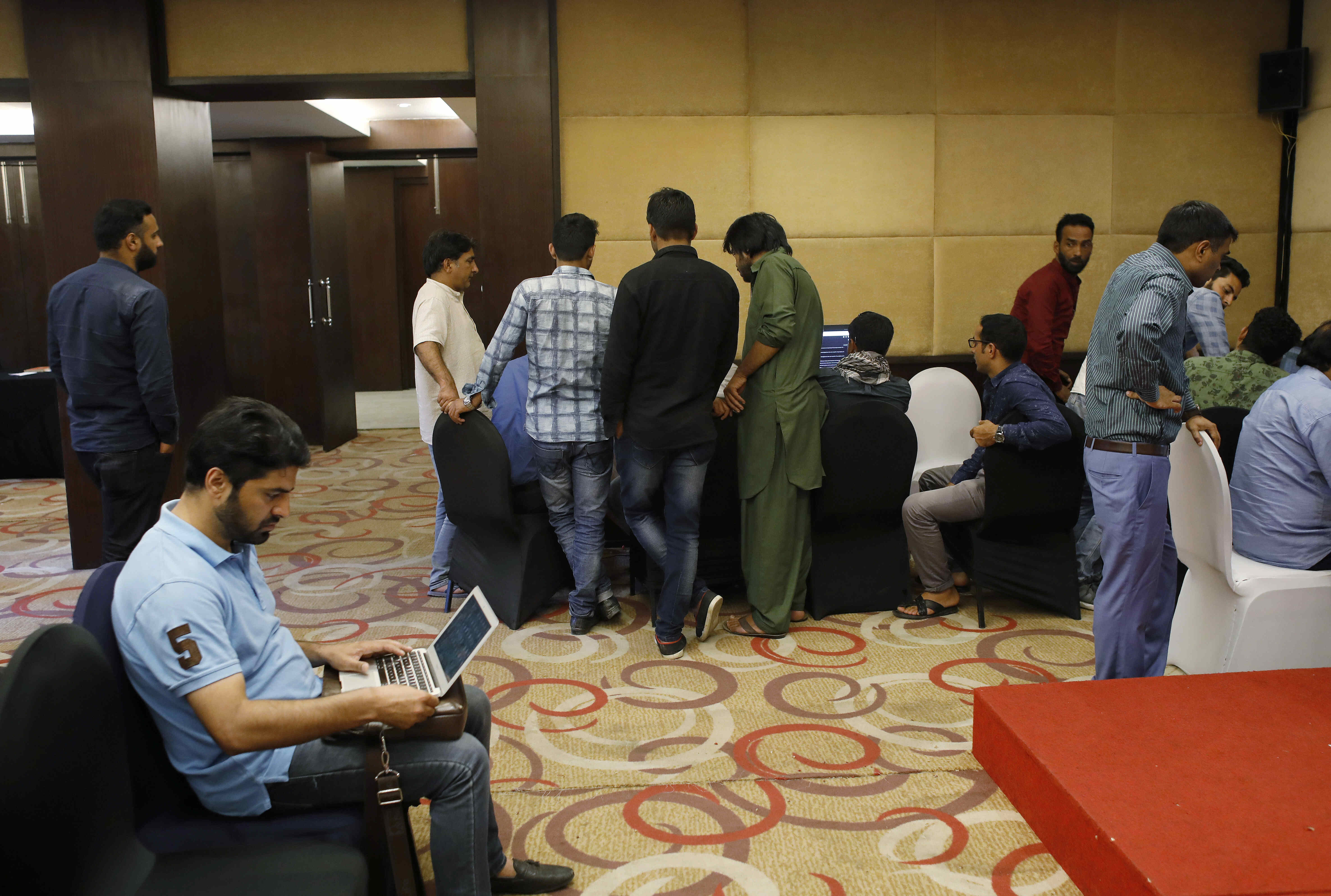 Journalists work at a government-run media centre at a hotel, during restrictions, after scrapping of the special constitutional status for Kashmir by the Indian government, in Srinagar, August 20, 2019. Picture taken August 20, 2019. REUTERS/Adnan Abidi