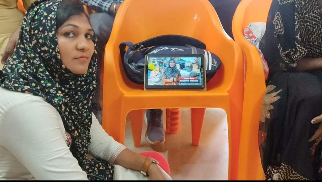 Shabnam showcasing her story on her smart device