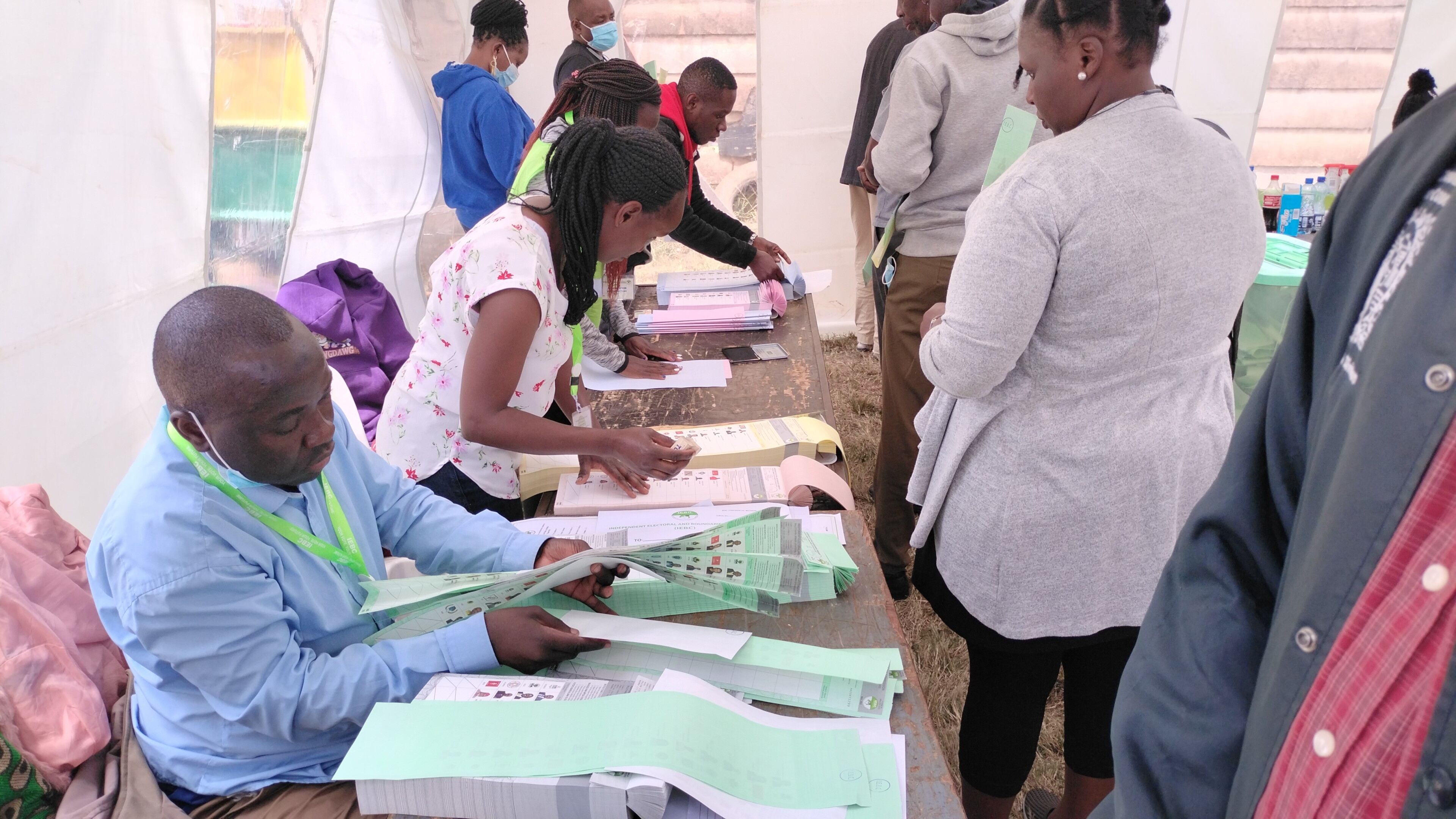 NAIROBI, KENYA- AUGUST 8, 2022: Independent Electoral and Boundaries Commission (IEBC) polling clerks process voters in Kasarani Constituency during the General Election.