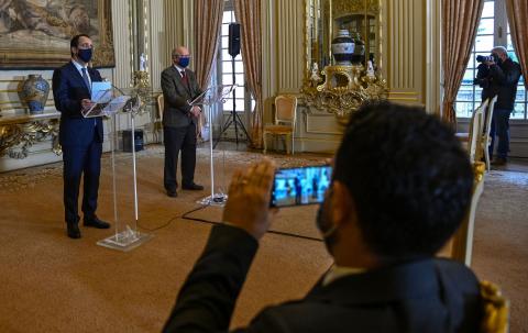 6: A journalist records with his cellphone the Minister of Foreign Affairs of Cyprus Nikos Christodoulides (L) and Portuguese Minister of State and Foreign Affairs Augusto Santos Silva (R) during a joint press conference .