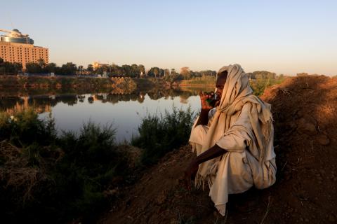 Sudan farmer sipping from a cup 