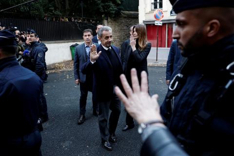 Sarkozy leaves his residence alongside wife Carla Bruni-Sarkozy. Picture: