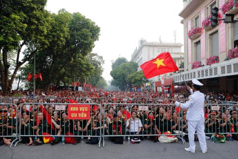 People wait to watch a parade marking Vietnam's 80th National Day anniversary, at a street in Hanoi, Vietnam Tuesday, Sept. 2, 2025. (Luong Thai Linh/Pool Photo via AP)