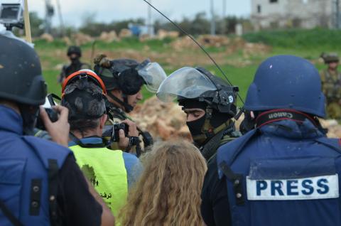 Palestinian protesters argue with Israeli soldiers who demand they disperse during the Friday protests, Nabi Saleh, West Bank, Palestine. 14/03/15