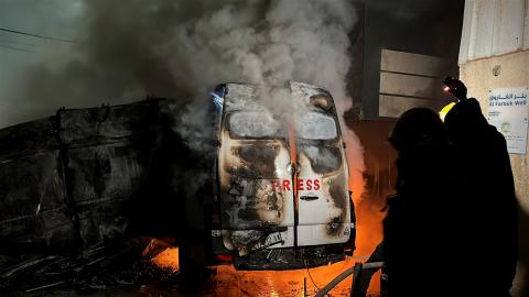 Civil Defense members put out a fire in a broadcast van following an Israeli strike in central Gaza December 26, 2024. (photo: Reuters)