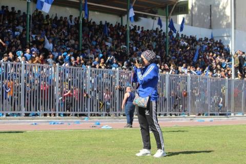 From Gaza, journalist Nelly El Masry bears witness to the war by documenting what remains of sports. Specializing in football, she recounts the destruction of stadiums and the upended daily lives of players. Despite the devastation, football remains for her a language of resistance, memory, and identity.