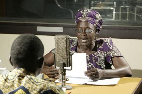 Woman talking on-air at a radio station, Garoua, Cameroon, Africa. 