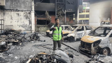 Kiran Paudel outside his Kantipur office which was burnt