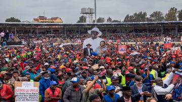 Azimio La Umoja (One Kenya Coalition Party) supporters wave a cardboard cutout with a picture of presidential candidate Raila Odinga and running mate Martha Karua during a campaign rally in Kirigiti Stadium, Kiambu, Kenya, Aug. 1, 2022. (AFP Photo)