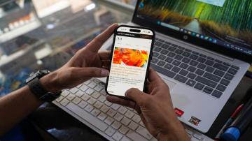 A reader accesses digital news coverage on a mobile device, highlighting the evolving landscape of digital journalism and media consumption. Photo: Sajad Hameed
