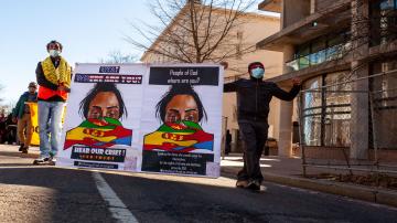 March against Ethiopia's war on Tigray, Washington, DC, USA  Two men carry a sign asking for assistance in ending Ethiopia's war on the Tigray people and region during a march downtown.  By: Allison Bailey / Date created: Feb 25 2021